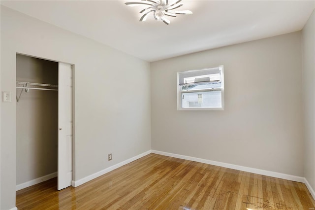 unfurnished bedroom with a closet and light hardwood / wood-style floors