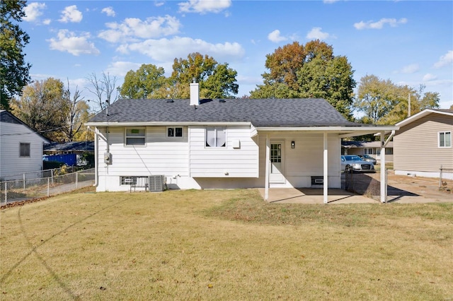 back of house with cooling unit, a patio area, and a yard