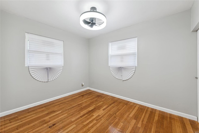 unfurnished room with hardwood / wood-style floors