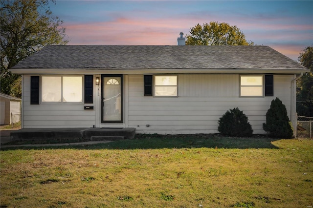 ranch-style home featuring a lawn