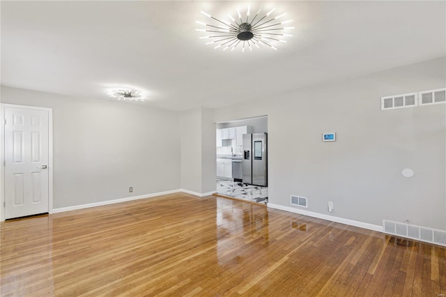 empty room with hardwood / wood-style flooring