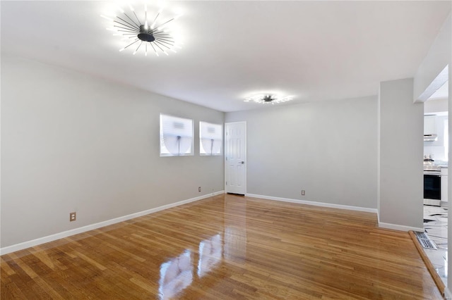 spare room with hardwood / wood-style floors