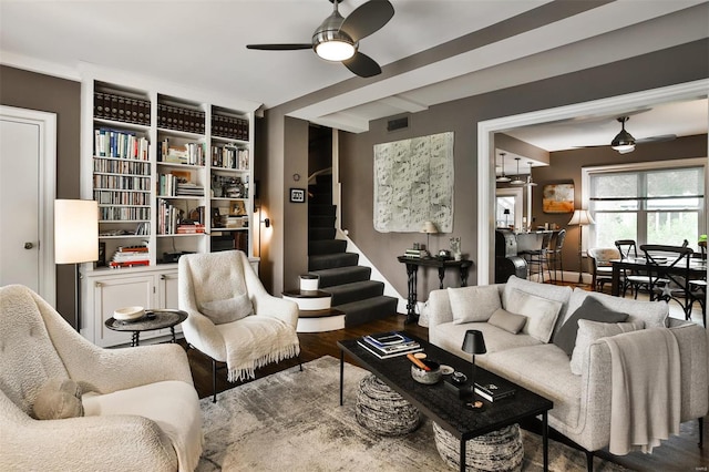 living room featuring hardwood / wood-style flooring and ceiling fan