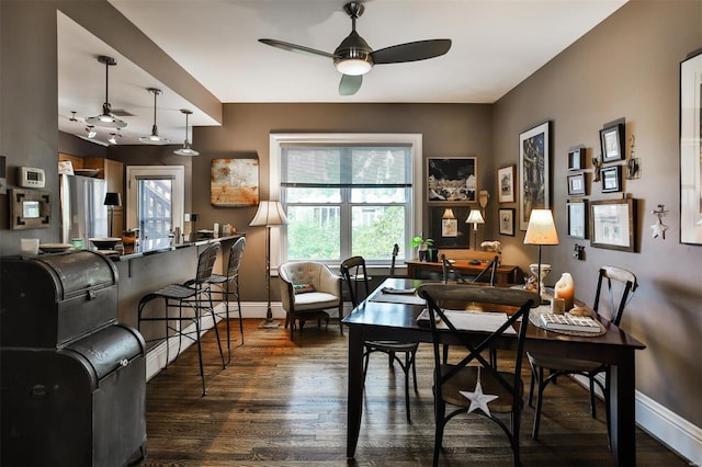 dining area featuring dark hardwood / wood-style flooring and ceiling fan