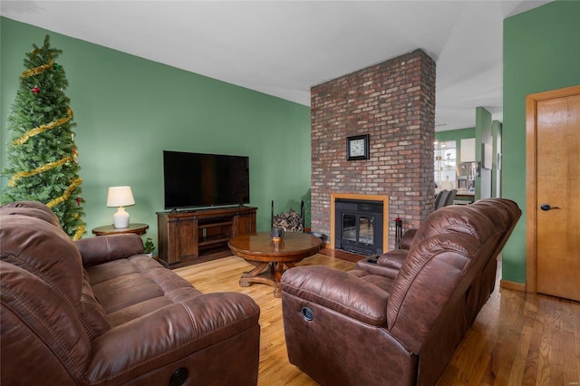 living room featuring a fireplace and light hardwood / wood-style flooring