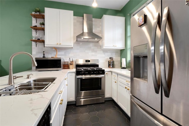 kitchen featuring stainless steel appliances, white cabinetry, wall chimney exhaust hood, and sink