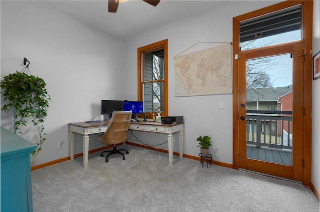 office space with light carpet, a wealth of natural light, and ceiling fan