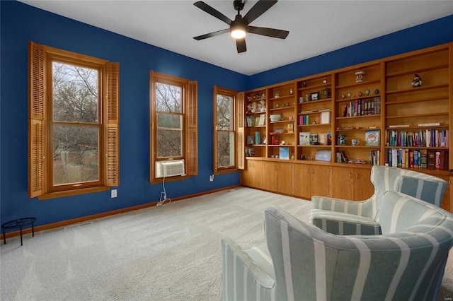 sitting room featuring light colored carpet, ceiling fan, and cooling unit