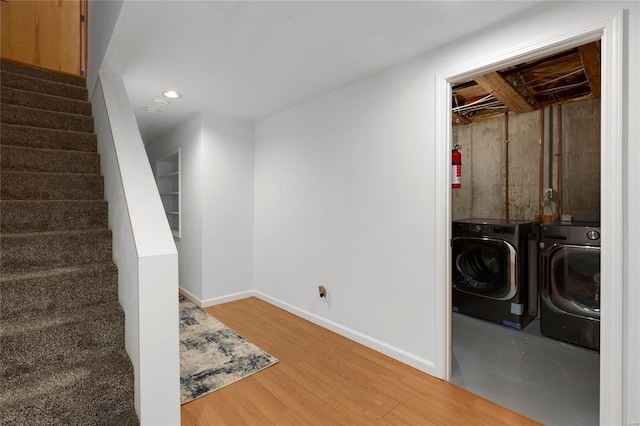 basement with wood-type flooring and independent washer and dryer