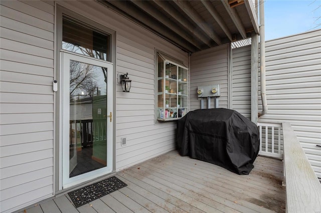 wooden terrace with a grill and a porch