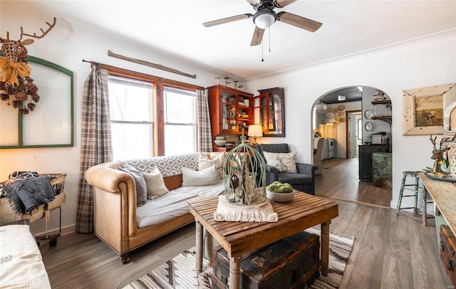 living room with ceiling fan and dark hardwood / wood-style floors