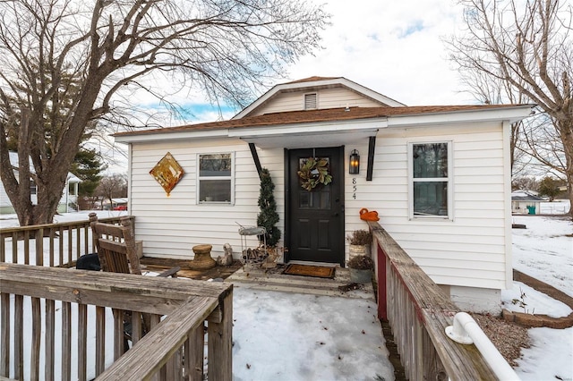 view of snow covered property entrance