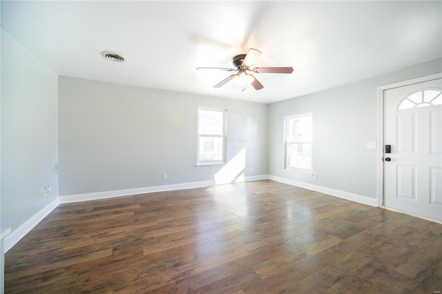 interior space with dark wood-type flooring and ceiling fan