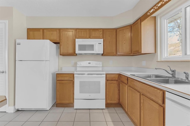 kitchen featuring light tile patterned flooring, sink, and white appliances