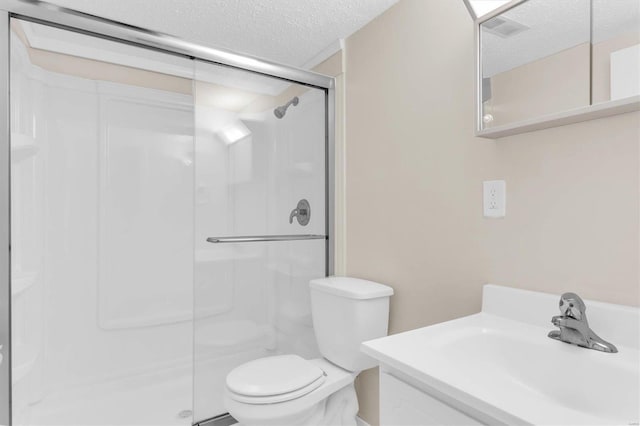 bathroom with an enclosed shower, a textured ceiling, and toilet