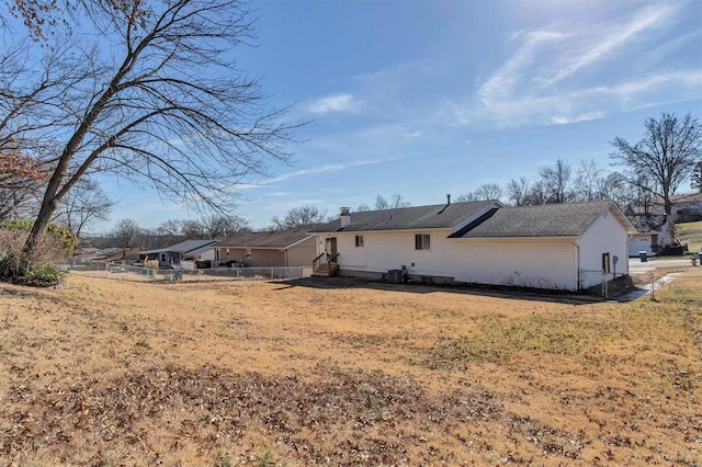 back of property with a lawn