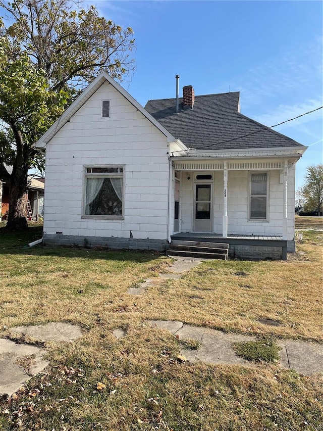 bungalow-style house with covered porch and a front lawn