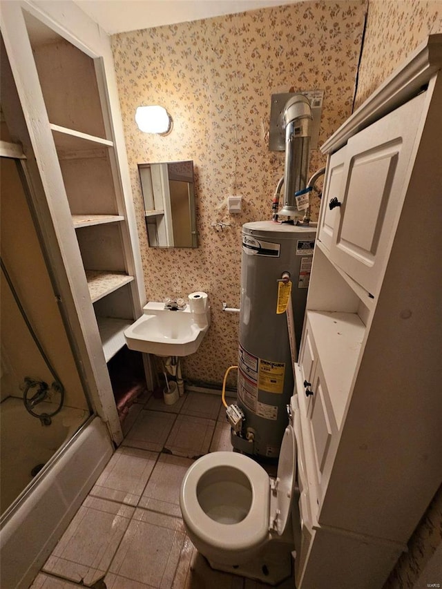 full bathroom with tile patterned floors, sink, shower / bath combination with glass door, water heater, and toilet