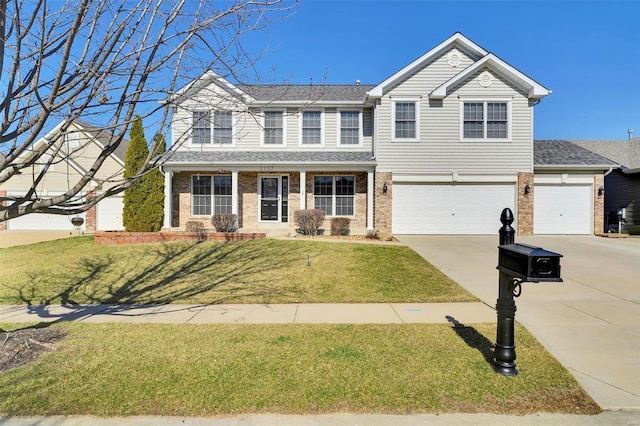 traditional home with brick siding, a shingled roof, concrete driveway, a front yard, and a garage