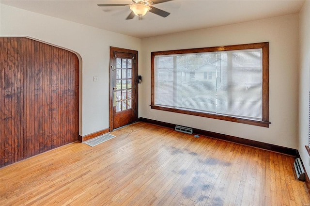 unfurnished room with light wood-type flooring and ceiling fan