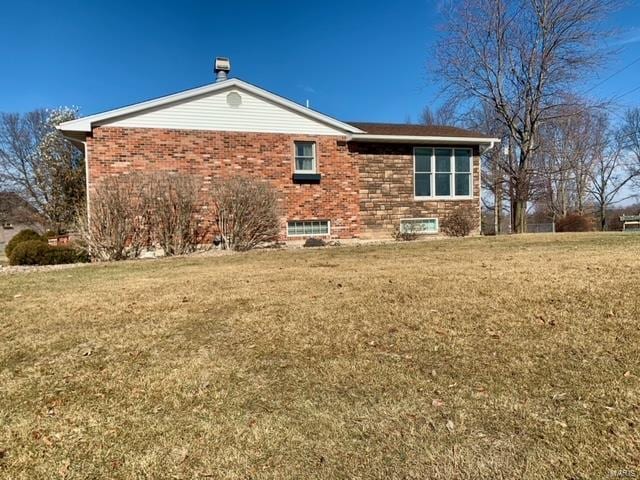 view of side of home with a lawn