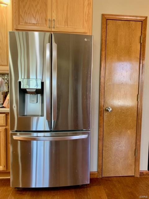 kitchen featuring backsplash, dark wood-type flooring, and stainless steel refrigerator with ice dispenser