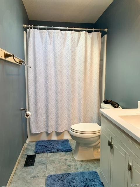 bathroom featuring vanity, toilet, and a shower with shower curtain