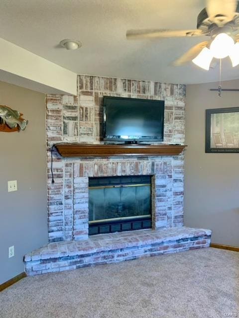 interior details featuring ceiling fan, a fireplace, and carpet floors