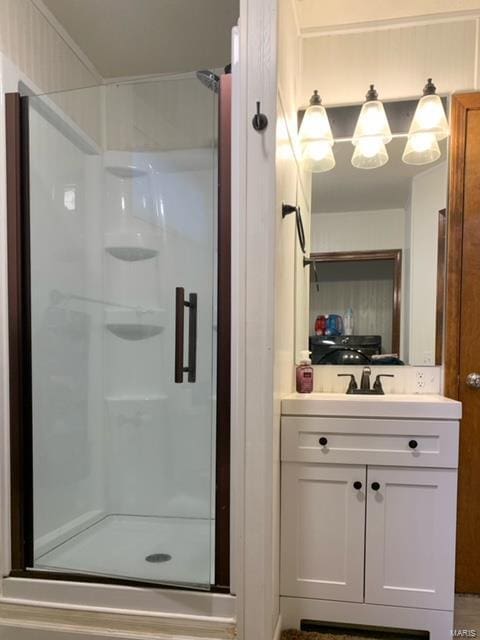 bathroom with a shower with door and vanity