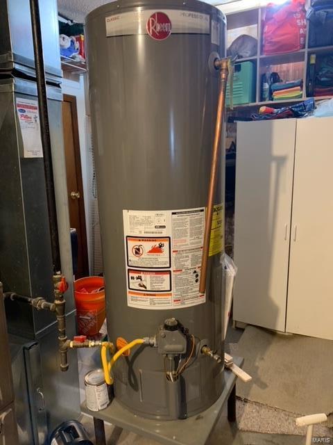 utility room with heating unit and gas water heater