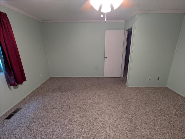 carpeted spare room featuring ceiling fan and crown molding