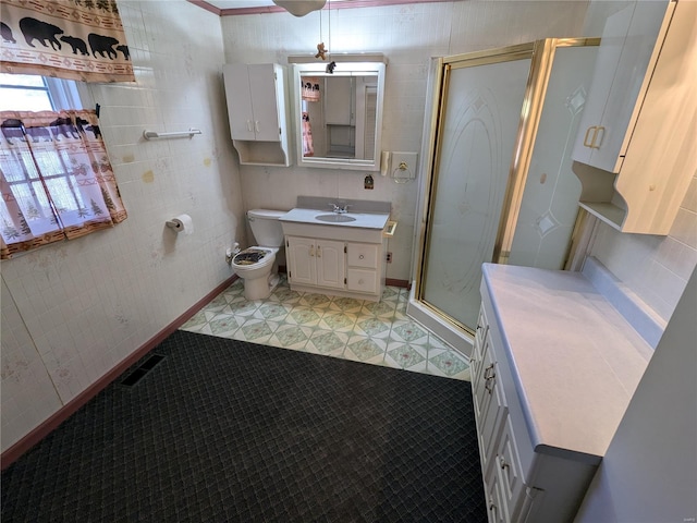 bathroom featuring tile walls, vanity, toilet, and a shower with door