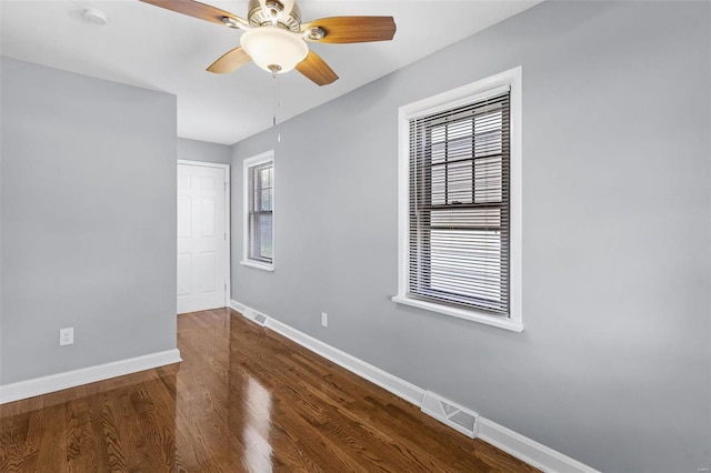 empty room featuring ceiling fan and dark hardwood / wood-style floors