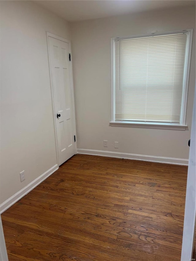 unfurnished room featuring dark hardwood / wood-style flooring