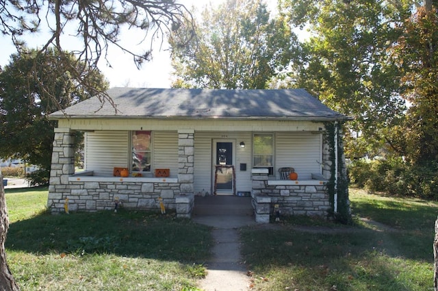 bungalow-style home with a front yard and a porch