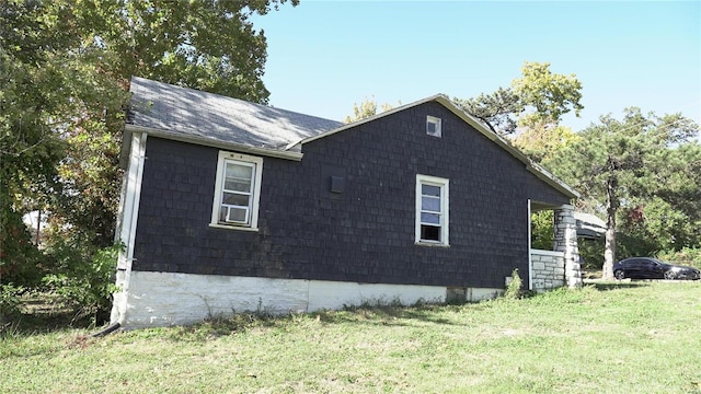 view of side of property with a yard