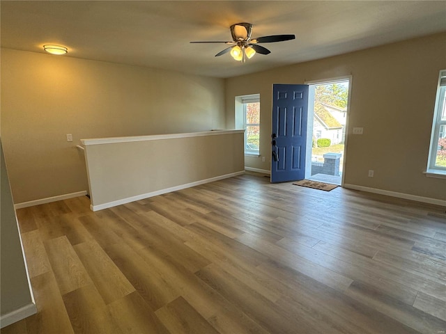 unfurnished room with hardwood / wood-style flooring and ceiling fan