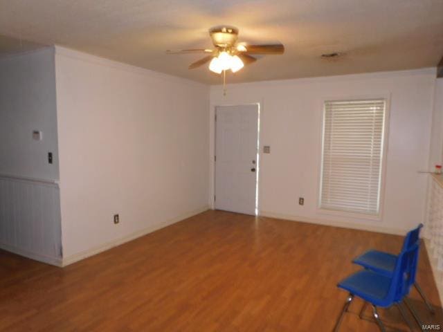 empty room with ceiling fan and wood-type flooring