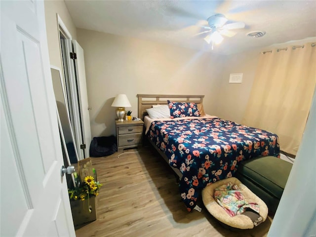 bedroom with light wood-type flooring and ceiling fan