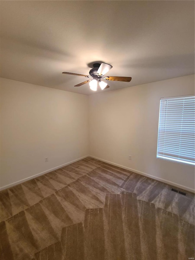 empty room with ceiling fan and carpet floors