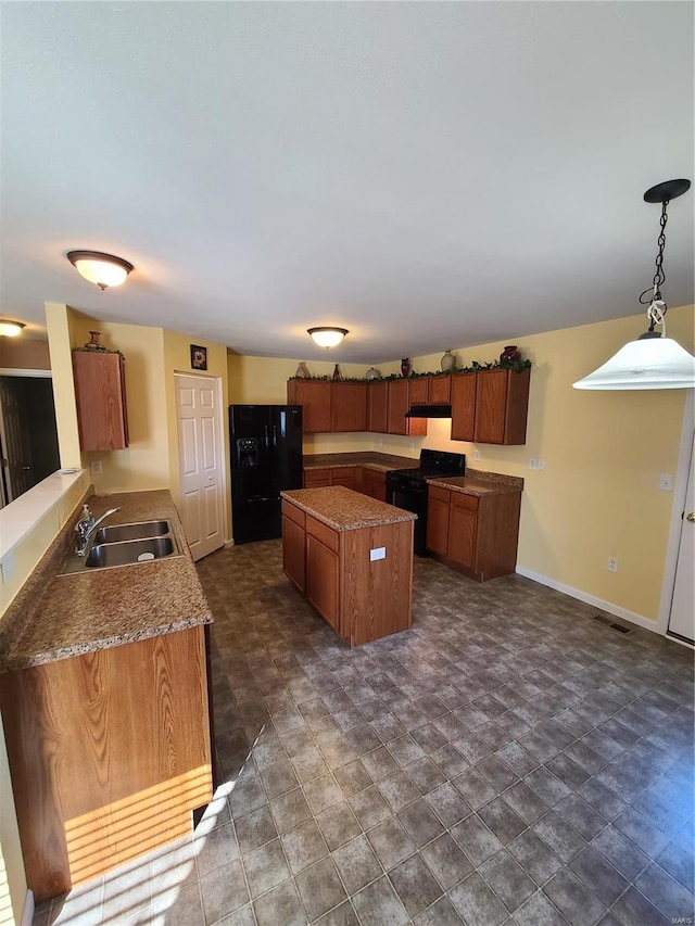 kitchen with pendant lighting, sink, and black appliances