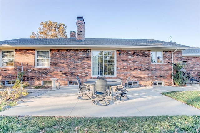 back of property with a patio