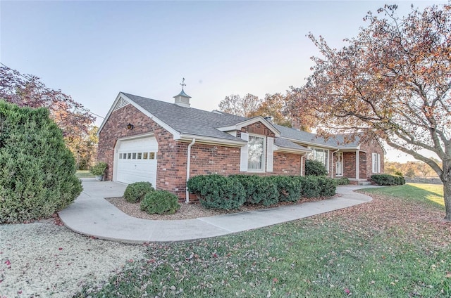 view of side of home with a garage and a yard