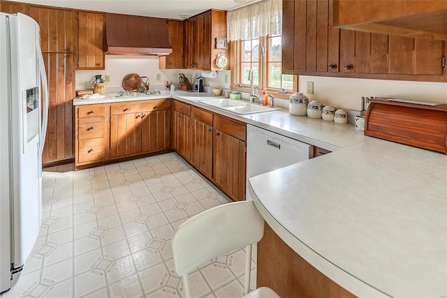 kitchen with custom exhaust hood, sink, and white appliances