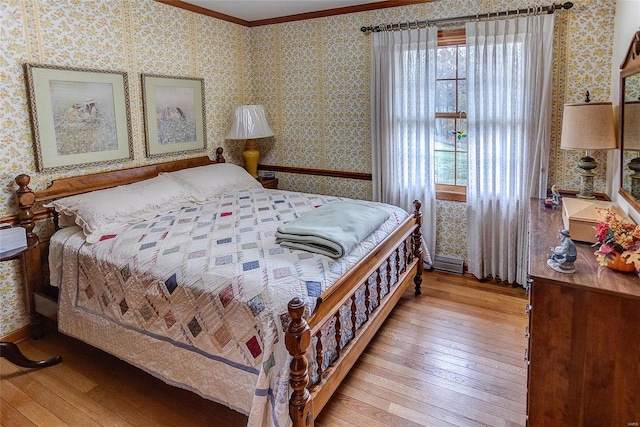 bedroom featuring light hardwood / wood-style flooring and crown molding