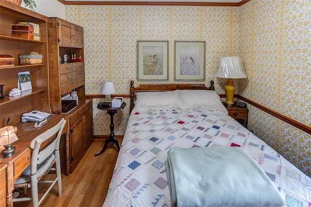 bedroom featuring light wood-type flooring and ornamental molding