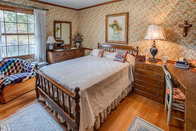 bedroom featuring crown molding and light hardwood / wood-style flooring