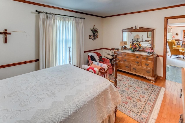 bedroom featuring light wood-type flooring and ornamental molding