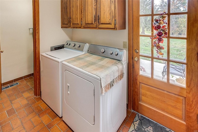 laundry room with cabinets and washer and dryer