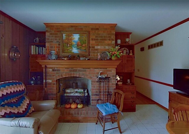 living room with a brick fireplace and crown molding